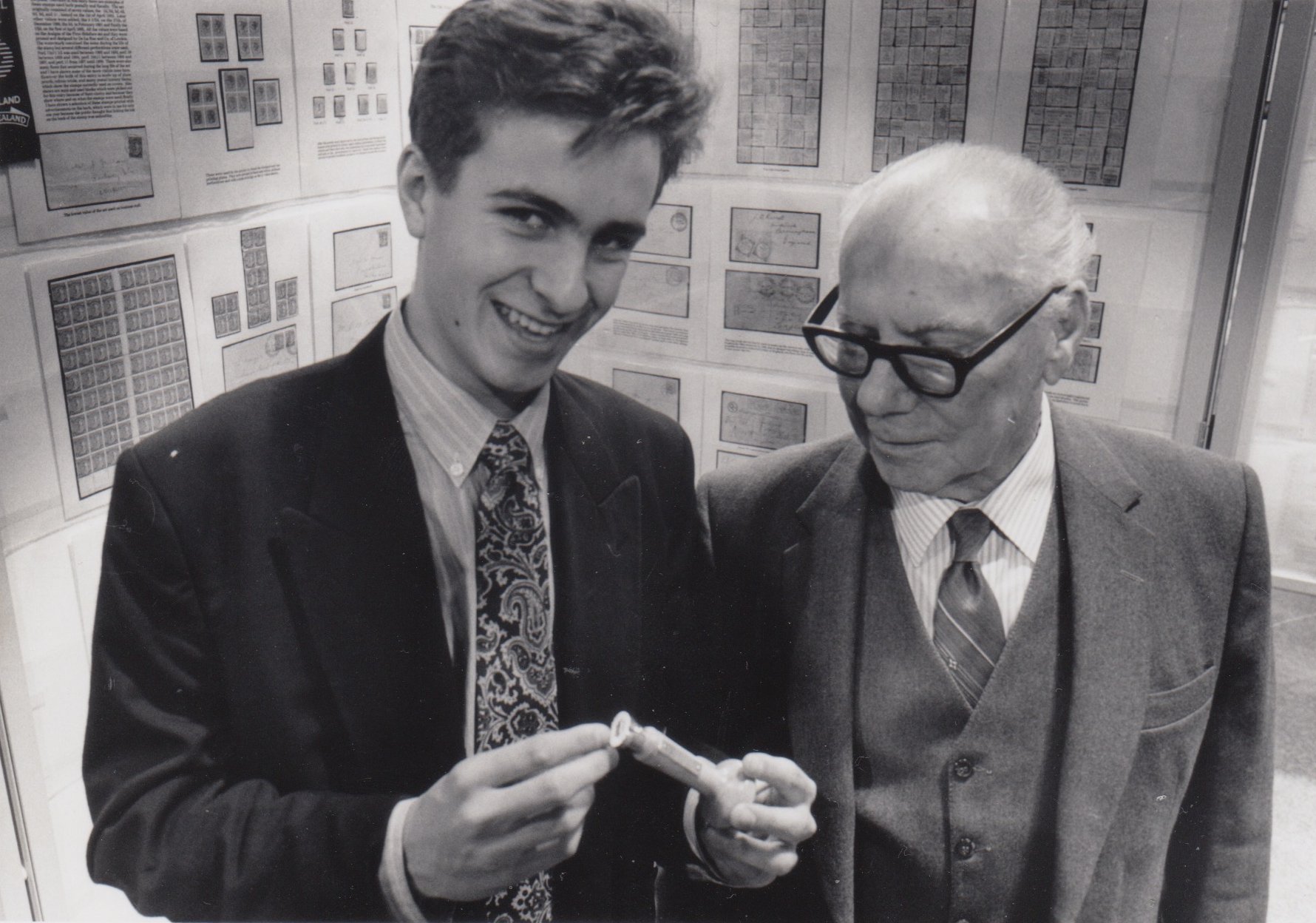 A young Nigel Shanks with his grandfather Jim Langabeer in front of exhibition frames